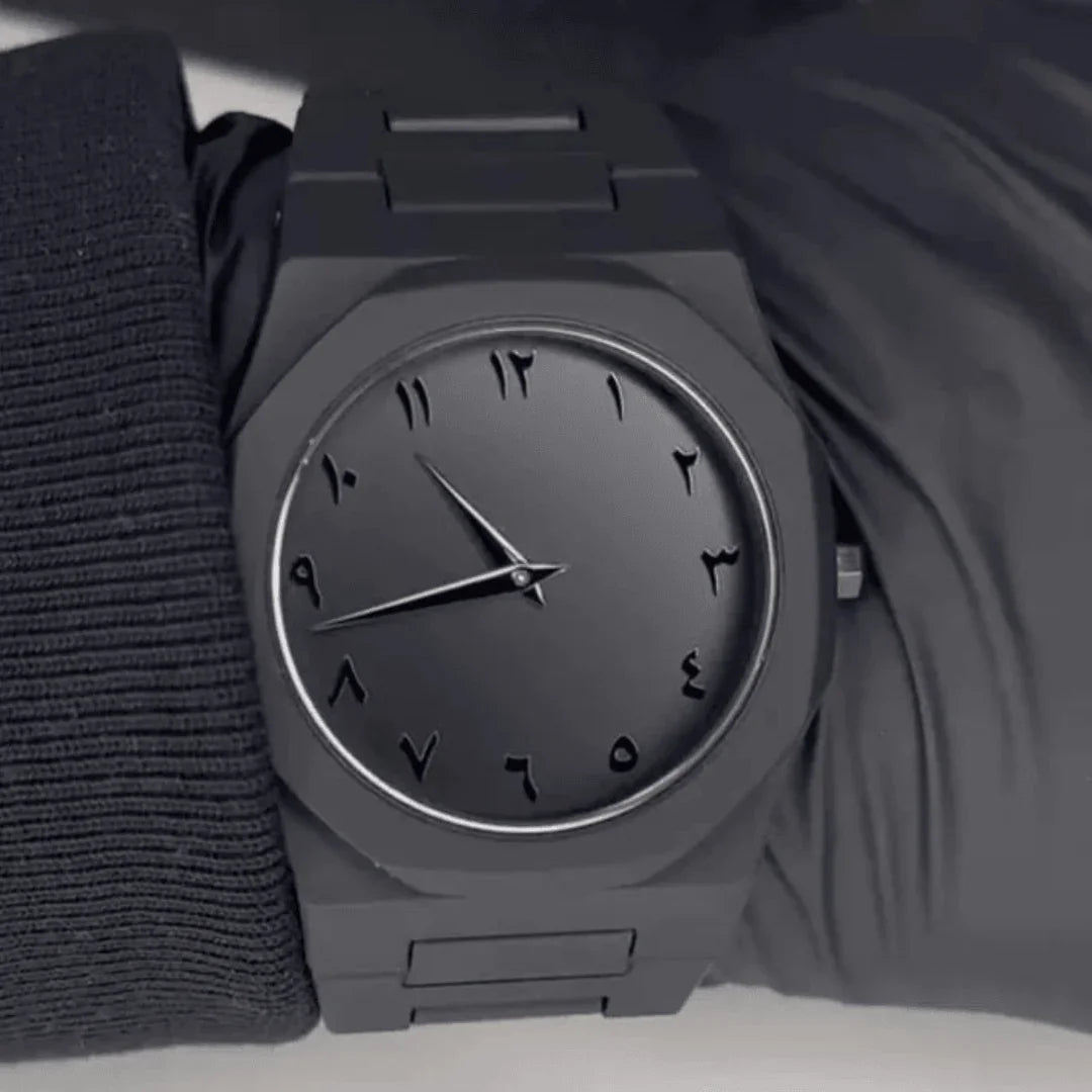All-black watch with Arabic numerals on wrist, metal band - Souq Sama UAE
