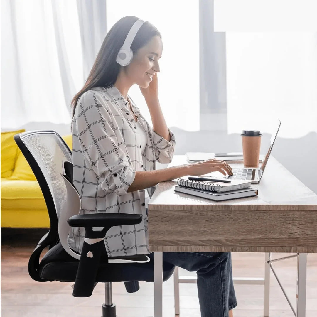 Woman working at desk with ergonomic office chair - Souq Sama UAE